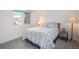 Comfortable bedroom featuring a bed with a patterned comforter, side table, and ample natural light at 7844 S Eudora Cir, Centennial, CO 80122