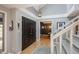 Bright foyer with hardwood floors, stairway, double front door, and stylish light fixture at 7844 S Eudora Cir, Centennial, CO 80122