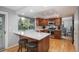 Bright kitchen with stainless steel appliances, wood cabinets, and a breakfast bar with seating at 7844 S Eudora Cir, Centennial, CO 80122