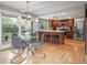 Open-concept kitchen and dining area with stainless appliances, island seating, and a modern chandelier at 7844 S Eudora Cir, Centennial, CO 80122