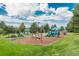 Community playground featuring slides, swings and benches surrounded by mature trees at 7844 S Eudora Cir, Centennial, CO 80122