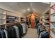Spacious walk-in closet with custom shelving and hanging rods for optimal organization and storage at 7844 S Eudora Cir, Centennial, CO 80122