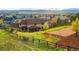 Expansive backyard with lush green grass, a wooden fence and mountain views in the background, offering a serene and private retreat at 3048 Starling Ct, Castle Rock, CO 80109