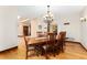Elegant dining room with hardwood floors, stylish chandelier, and views into the entryway and other rooms at 3048 Starling Ct, Castle Rock, CO 80109