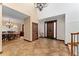 Grand foyer with custom wood doors, travertine tile, chandelier and dining room view at 3048 Starling Ct, Castle Rock, CO 80109