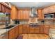 Well-appointed kitchen with custom cabinetry, granite countertops, stainless steel appliances, and a view to the outdoors over the sink at 3048 Starling Ct, Castle Rock, CO 80109