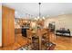Open-concept kitchen and dining area with stainless steel appliances, wood cabinets, a center island, and hardwood floors at 3048 Starling Ct, Castle Rock, CO 80109