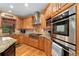 Gourmet kitchen featuring custom wood cabinets, granite countertops, stainless steel appliances, and hardwood floors for a chef's delight at 3048 Starling Ct, Castle Rock, CO 80109