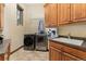 The laundry room includes a sink, washer, dryer, countertop space, and custom wood cabinets at 3048 Starling Ct, Castle Rock, CO 80109