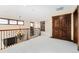Bright loft area featuring plush carpeting, an elegant chandelier, and natural light from multiple windows at 3048 Starling Ct, Castle Rock, CO 80109