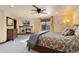 Spacious main bedroom featuring a fireplace, plush carpet, ceiling fan, and natural light from the window at 3048 Starling Ct, Castle Rock, CO 80109