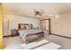 A spacious main bedroom featuring a ceiling fan and a seating bench at the end of the bed at 3048 Starling Ct, Castle Rock, CO 80109