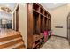 Entryway featuring custom wood mudroom lockers, tile floors, and an open view to the kitchen at 3048 Starling Ct, Castle Rock, CO 80109