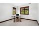 A bright office with natural light, two windows and wood trim with a simple desk at 3048 Starling Ct, Castle Rock, CO 80109