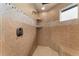 Beautifully tiled shower with built-in shelves and a rain shower head for a spa-like experience at 3048 Starling Ct, Castle Rock, CO 80109