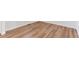 Close-up of a hardwood floor with light wood tones and a sleek finish, offering a modern and inviting look at 955 Tallus St, Lochbuie, CO 80603