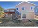 Multi-level backyard with a wooden deck and stone accents, perfect for outdoor entertaining at 11933 W 83Rd Ln, Arvada, CO 80005