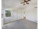 Bedroom featuring neutral carpet, large windows, and adjacent access to other rooms at 11933 W 83Rd Ln, Arvada, CO 80005