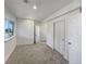 Bedroom with large window, neutral carpet and trim, and a closet at 11933 W 83Rd Ln, Arvada, CO 80005