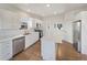 Modern kitchen featuring white cabinetry, stainless steel appliances, and a center island at 11933 W 83Rd Ln, Arvada, CO 80005