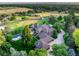 Scenic aerial view of an expansive estate with a pool, manicured lawns, and lush landscaping at 5 Random Rd, Cherry Hills Village, CO 80113