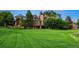 Expansive lawn and well-maintained landscaping surrounding this elegant house at 5 Random Rd, Cherry Hills Village, CO 80113