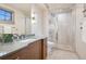 Bathroom featuring a glass enclosed shower and dual sink vanity with marble countertops at 5 Random Rd, Cherry Hills Village, CO 80113