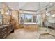 Bathroom featuring a luxurious bathtub, glass enclosed shower, and marble countertops at 5 Random Rd, Cherry Hills Village, CO 80113