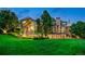 Stunning home exterior with a beautiful lawn, large windows, and stone accents at 5 Random Rd, Cherry Hills Village, CO 80113