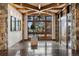 Elegant foyer with hardwood floors, stone accents, and a striking view of the outdoors at 5 Random Rd, Cherry Hills Village, CO 80113
