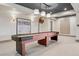 Finished basement with a shuffleboard table, custom lighting, and neutral decor at 5 Random Rd, Cherry Hills Village, CO 80113