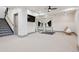 Bright gym area with mirrors, ceiling fan, and access to a staircase with patterned risers at 5 Random Rd, Cherry Hills Village, CO 80113