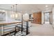 Upstairs hallway with modern railing and elegant pendant lighting, creating an open and airy feel at 5 Random Rd, Cherry Hills Village, CO 80113