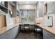 Bright home office featuring custom built-ins, dual desk spaces, and a large window with scenic views at 5 Random Rd, Cherry Hills Village, CO 80113