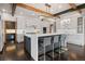 Stylish kitchen with a large island, stainless steel appliances, hardwood floors, and modern light fixtures at 5 Random Rd, Cherry Hills Village, CO 80113