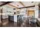 Modern kitchen with bar seating, stainless steel appliances, custom cabinets, and hardwood floors at 5 Random Rd, Cherry Hills Village, CO 80113