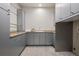 Spacious laundry room with ample cabinet storage, granite countertops, and a utility sink at 5 Random Rd, Cherry Hills Village, CO 80113