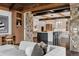 Open-concept living room flowing to kitchen and dining area, featuring modern furnishings and stone accents at 5 Random Rd, Cherry Hills Village, CO 80113