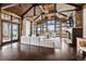 Bright living room with vaulted ceilings, large windows, a stone fireplace, and wood accents at 5 Random Rd, Cherry Hills Village, CO 80113