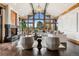 Bright living room features vaulted ceilings, a fireplace, hardwood floors, and oversized windows at 5 Random Rd, Cherry Hills Village, CO 80113