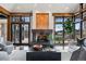 Cozy living room with a modern fireplace, large windows, and comfortable seating at 5 Random Rd, Cherry Hills Village, CO 80113