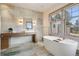 Luxurious main bathroom with a soaking tub, stone accents, and modern fixtures for a spa-like experience at 5 Random Rd, Cherry Hills Village, CO 80113