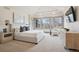 Serene main bedroom with tray ceilings, large windows, and stylish furnishings for ultimate comfort at 5 Random Rd, Cherry Hills Village, CO 80113