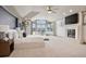 Spacious main bedroom with a fireplace, high ceilings, ample natural light, and an attached seating area at 5 Random Rd, Cherry Hills Village, CO 80113