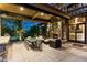 Inviting outdoor patio with stone fireplace, dining table, and comfortable seating area at 5 Random Rd, Cherry Hills Village, CO 80113