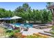 Beautiful backyard pool and spa surrounded by lush landscaping and lounge seating, ideal for relaxation at 5 Random Rd, Cherry Hills Village, CO 80113