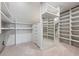 Walk-in closet with custom shelving, drawers, and a full-length mirror for ample storage at 5 Random Rd, Cherry Hills Village, CO 80113
