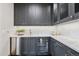 Elegant wet bar featuring sleek cabinetry, stainless steel mini fridge, and a stylish backsplash at 5 Random Rd, Cherry Hills Village, CO 80113