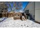 Deck and backyard with snow and AC unit at 1621 Flemming Dr, Longmont, CO 80501