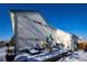 Large backyard with snow-covered ground, deck, and shed at 1621 Flemming Dr, Longmont, CO 80501